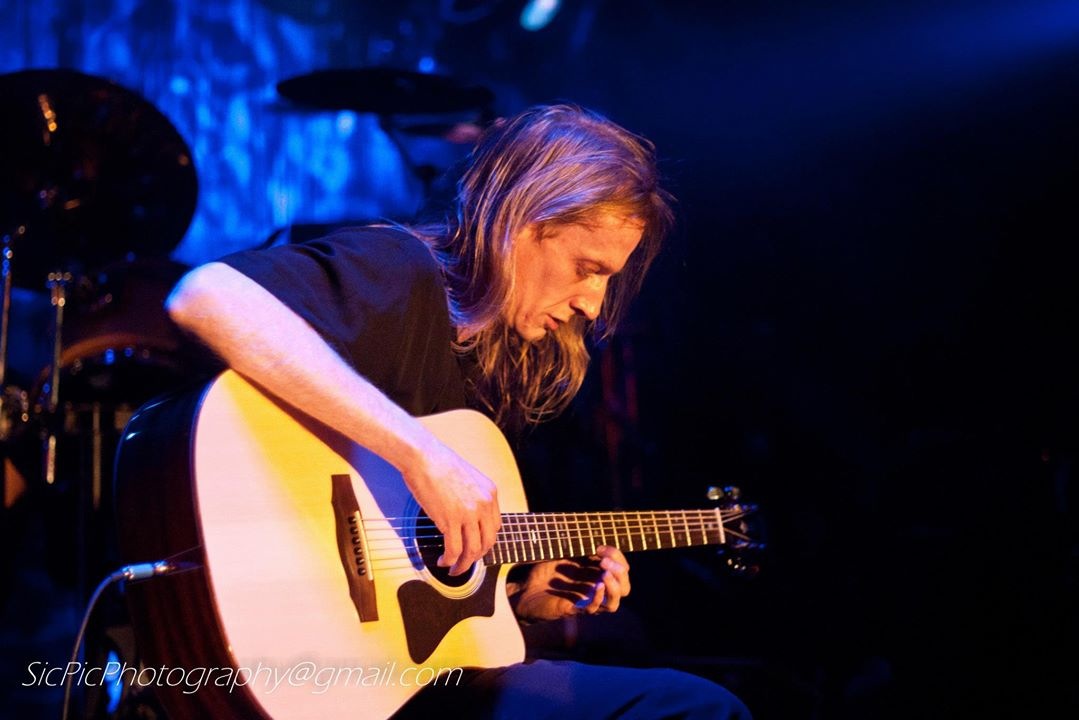Ray playing acoustic guitar